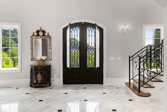 1024 Vaughn Crest Dr, Franklin, TN 37069 - entrance foyer with arched walkways, plenty of natural light, french doors, and stairs