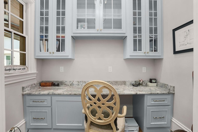 1024 Vaughn Crest Dr, Franklin, TN 37069 - kitchen with gray cabinets, glass insert cabinets, and light stone countertops