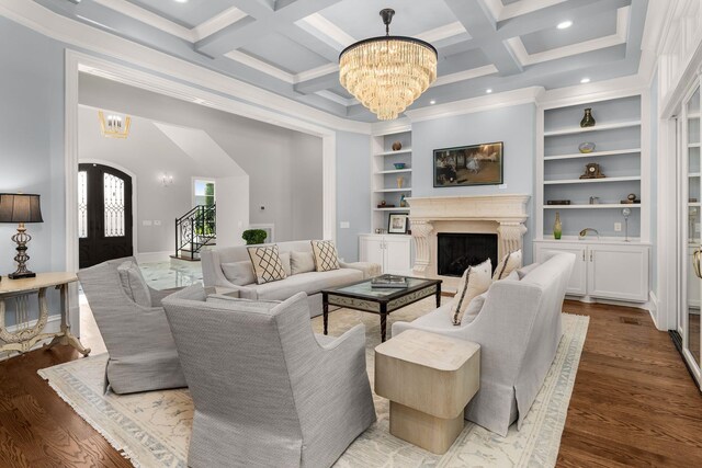 1024 Vaughn Crest Dr, Franklin, TN 37069 - living room with a chandelier, a fireplace, built in features, beam ceiling, and wood finished floors