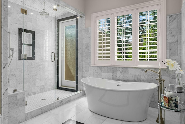 1024 Vaughn Crest Dr, Franklin, TN 37069 - full bathroom featuring plenty of natural light, a marble finish shower, tile walls, and a freestanding tub