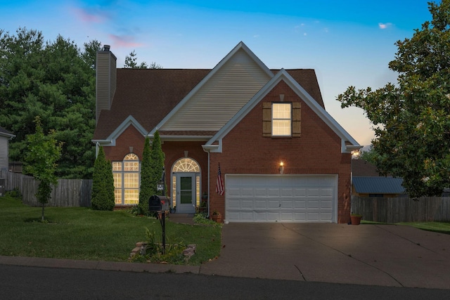 2104 Loudenslager Dr, Thompsons Station, TN 37179 - traditional home with driveway, brick siding, an attached garage, and a chimney