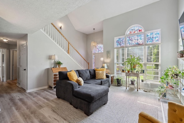 2104 Loudenslager Dr, Thompsons Station, TN 37179 - living area with a chandelier, stairway, wood finished floors, a towering ceiling, and a textured ceiling