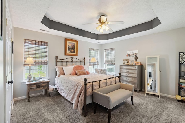 2104 Loudenslager Dr, Thompsons Station, TN 37179 - carpeted bedroom featuring a tray ceiling, multiple windows, a ceiling fan, and a textured ceiling