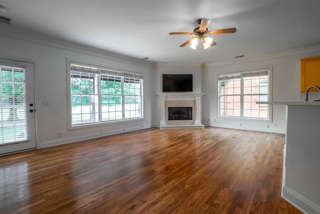 1159 Fairvue Village Ln, Gallatin, TN 37066 - unfurnished living room featuring wood finished floors, a ceiling fan, crown molding, a glass covered fireplace, and baseboards
