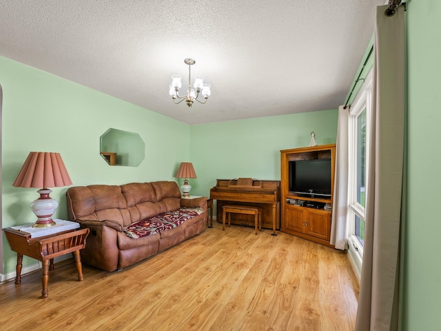 1574 Midway Rd, Sewanee, TN 37375 - living room with light wood-style floors, a chandelier, and a textured ceiling
