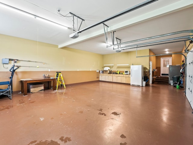 1574 Midway Rd, Sewanee, TN 37375 - garage featuring freestanding refrigerator and a garage door opener