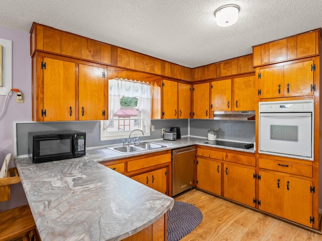 1574 Midway Rd, Sewanee, TN 37375 - kitchen with black appliances, a textured ceiling, a sink, a peninsula, and brown cabinets
