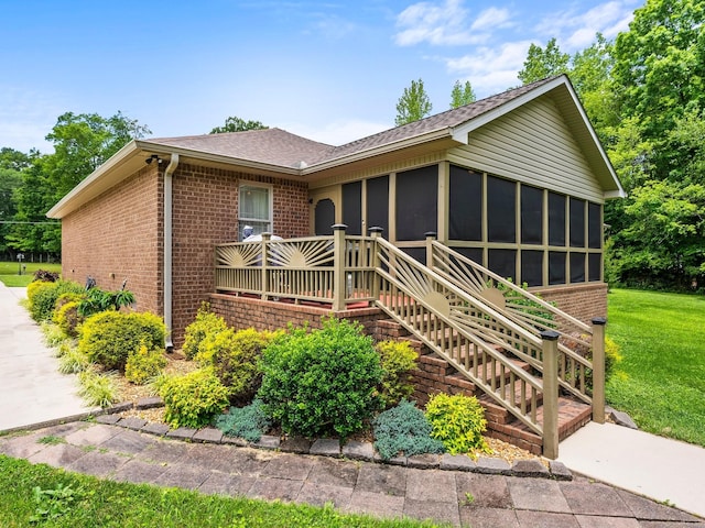 1574 Midway Rd, Sewanee, TN 37375 - single story home featuring brick siding, a sunroom, a front yard, and a shingled roof