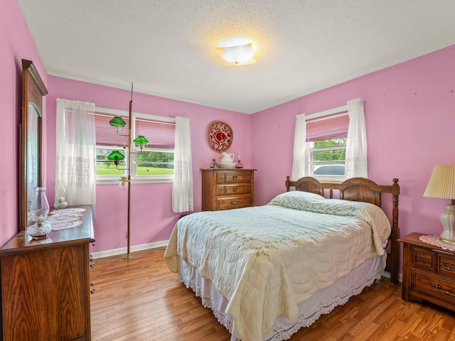 1574 Midway Rd, Sewanee, TN 37375 - bedroom with wood finished floors, a textured ceiling, and baseboards