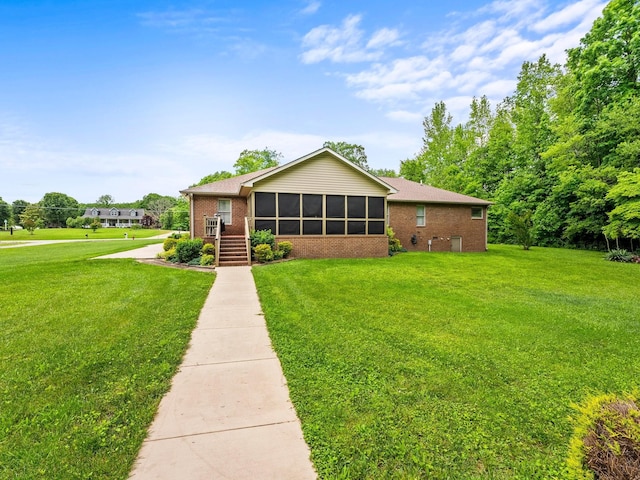 1574 Midway Rd, Sewanee, TN 37375 - ranch-style home featuring brick siding, a front lawn, and a sunroom