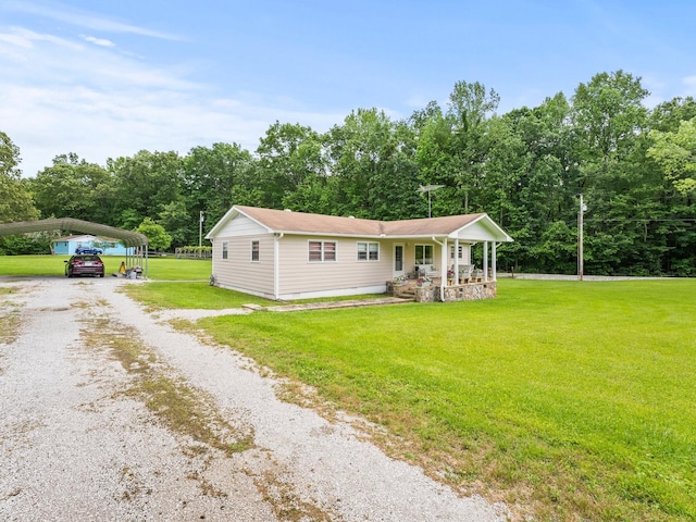 1574 Midway Rd, Sewanee, TN 37375 - view of front facade with driveway, covered porch, a front lawn, and a detached carport
