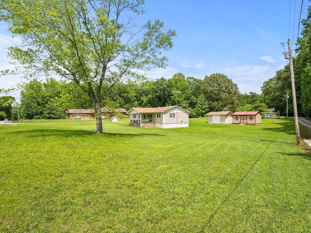 1574 Midway Rd, Sewanee, TN 37375 - view of green lawn featuring an outbuilding and view of wooded area