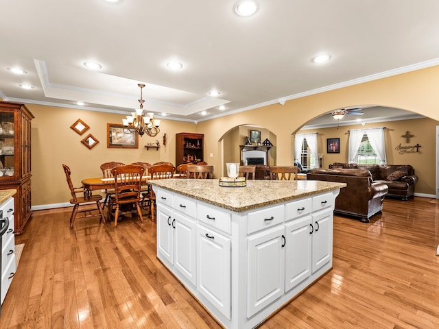 1574 Midway Rd, Sewanee, TN 37375 - kitchen with arched walkways, ornamental molding, a kitchen island, light wood-style floors, and open floor plan
