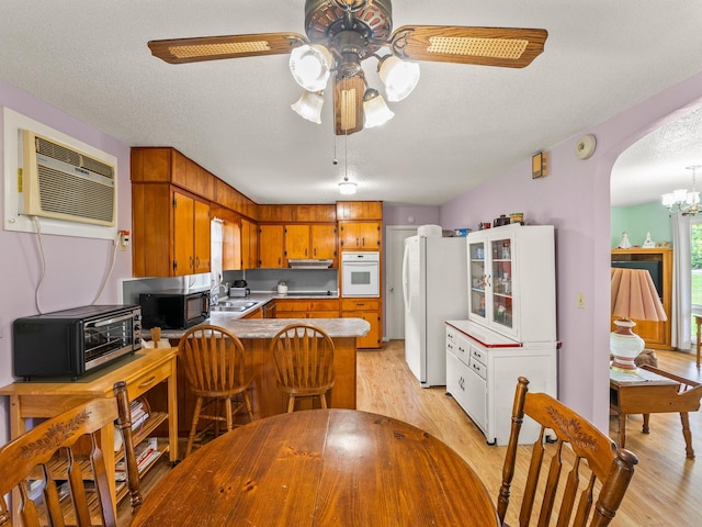 1574 Midway Rd, Sewanee, TN 37375 - kitchen with white appliances, a sink, an AC wall unit, ceiling fan, and a peninsula