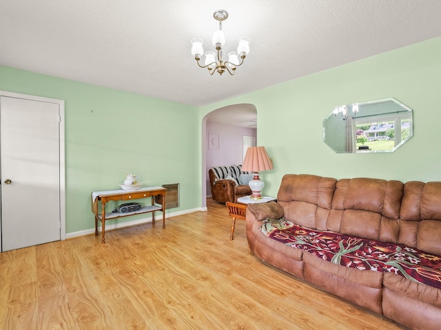 1574 Midway Rd, Sewanee, TN 37375 - living area featuring arched walkways, wood finished floors, and a chandelier