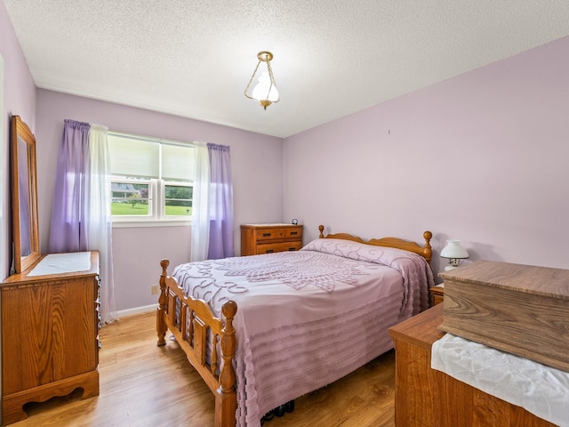 1574 Midway Rd, Sewanee, TN 37375 - bedroom with wood finished floors, a textured ceiling, and baseboards