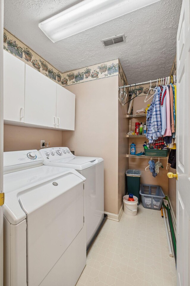 6873 Giles Hill Rd, College Grove, TN 37046 - laundry room featuring washer and clothes dryer, cabinet space, a textured ceiling, and baseboards