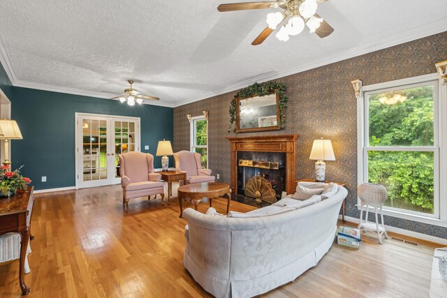6873 Giles Hill Rd, College Grove, TN 37046 - living room with a ceiling fan, wood finished floors, a fireplace, baseboards, and a textured ceiling