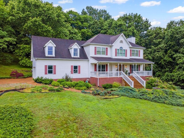 6873 Giles Hill Rd, College Grove, TN 37046 - view of front facade with covered porch, a chimney, and a front lawn