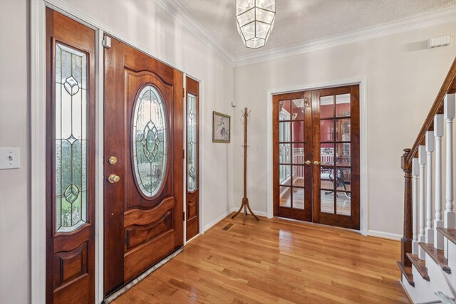 6873 Giles Hill Rd, College Grove, TN 37046 - foyer featuring french doors, stairway, light wood-style flooring, ornamental molding, and baseboards