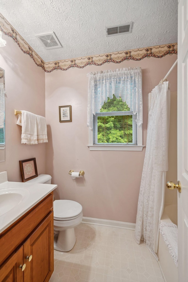 6873 Giles Hill Rd, College Grove, TN 37046 - bathroom featuring vanity, toilet, a textured ceiling, and baseboards