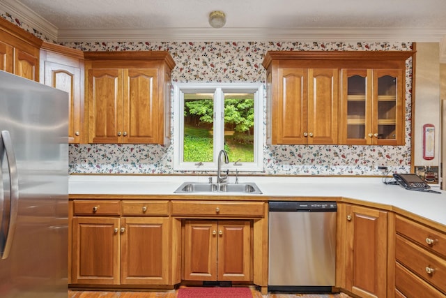 6873 Giles Hill Rd, College Grove, TN 37046 - kitchen featuring stainless steel appliances, wallpapered walls, a sink, light countertops, and brown cabinetry