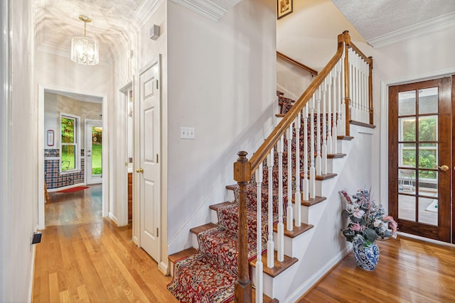 6873 Giles Hill Rd, College Grove, TN 37046 - foyer with light wood-type flooring, stairway, crown molding, a chandelier, and baseboards