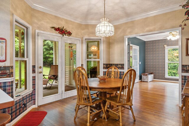 6873 Giles Hill Rd, College Grove, TN 37046 - dining area featuring wood finished floors, healthy amount of natural light, a chandelier, ornamental molding, and wallpapered walls