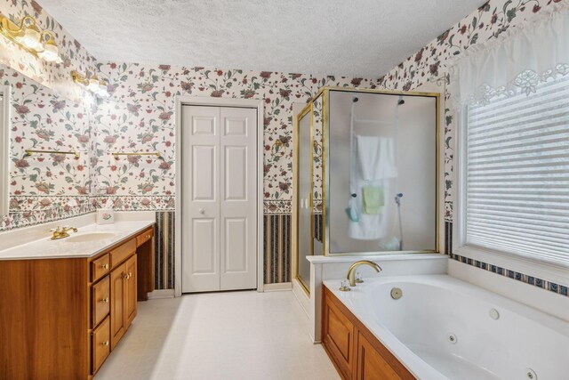 6873 Giles Hill Rd, College Grove, TN 37046 - bathroom featuring wallpapered walls, a textured ceiling, a shower stall, a jetted tub, and vanity