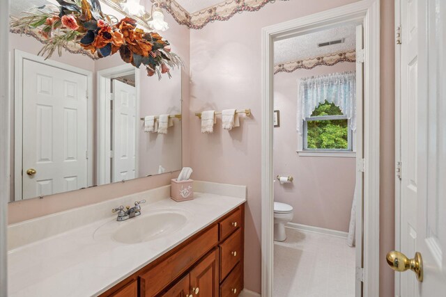 6873 Giles Hill Rd, College Grove, TN 37046 - bathroom featuring vanity, toilet, and baseboards