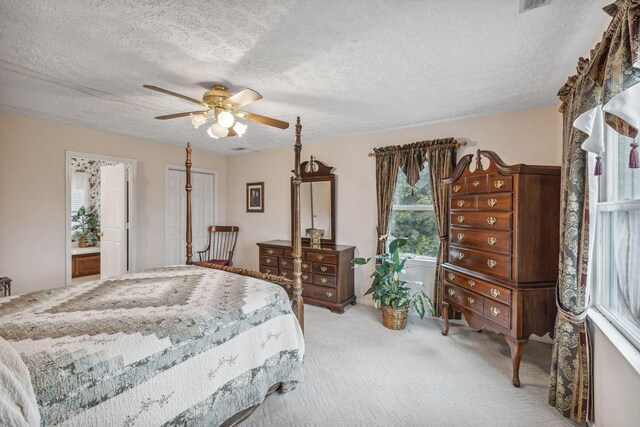 6873 Giles Hill Rd, College Grove, TN 37046 - bedroom with a textured ceiling, light carpet, ceiling fan, and connected bathroom