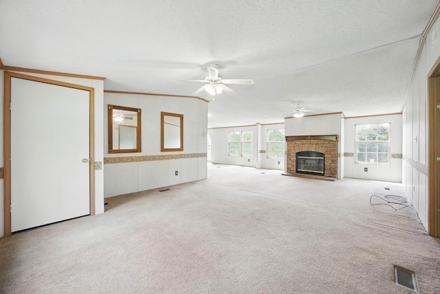 947 Buck Branch Rd, Charlotte, TN 37036 - unfurnished living room featuring ceiling fan, carpet, ornamental molding, a textured ceiling, and a glass covered fireplace
