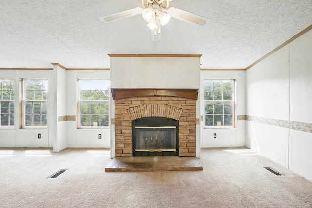 947 Buck Branch Rd, Charlotte, TN 37036 - unfurnished living room with ornamental molding, a textured ceiling, carpet floors, a glass covered fireplace, and a ceiling fan