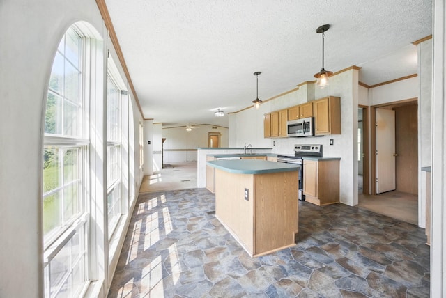 947 Buck Branch Rd, Charlotte, TN 37036 - kitchen with appliances with stainless steel finishes, crown molding, stone floors, a kitchen island, and a textured ceiling