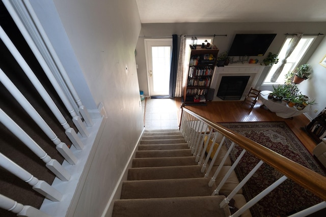 674 Superior Ln, Clarksville, TN 37043 - staircase featuring healthy amount of natural light and a fireplace with flush hearth