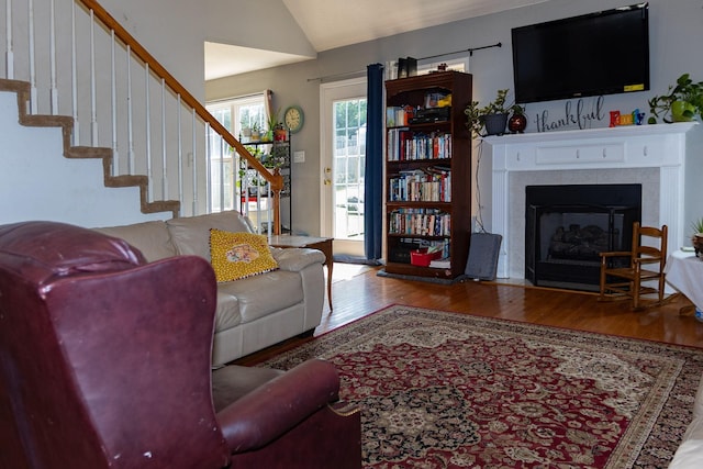 674 Superior Ln, Clarksville, TN 37043 - living area with wood finished floors, lofted ceiling, stairs, and a fireplace with flush hearth