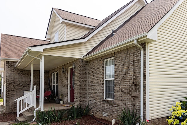 674 Superior Ln, Clarksville, TN 37043 - view of side of home featuring crawl space, a shingled roof, brick siding, and covered porch