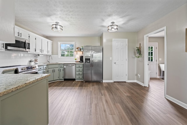 2237 Cold Springs Rd, Lafayette, TN 37083 - kitchen featuring stainless steel appliances, dark wood finished floors, a sink, tasteful backsplash, and a textured ceiling