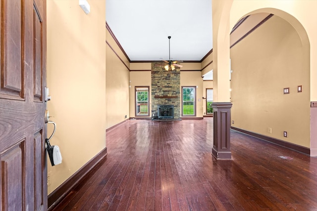 3696 Prestwicke Pl, Adams, TN 37010 - unfurnished living room with ceiling fan, dark wood-style floors, a fireplace, crown molding, and a towering ceiling