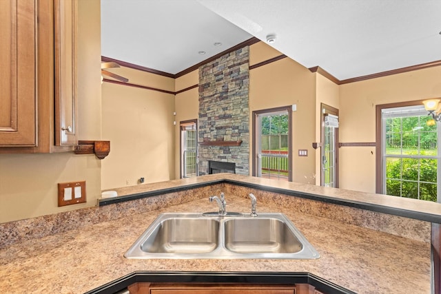 3696 Prestwicke Pl, Adams, TN 37010 - kitchen featuring crown molding, a fireplace, light countertops, and ceiling fan