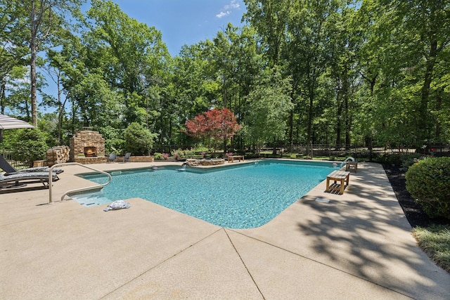 1150 Deer Run Rd, Murfreesboro, TN 37128 - view of pool with an outdoor stone fireplace, a patio, and view of wooded area