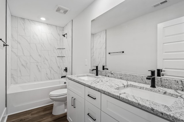 556 Kingwood Ln, White House, TN 37188 - bathroom featuring toilet, double vanity, washtub / shower combination, and wood finished floors