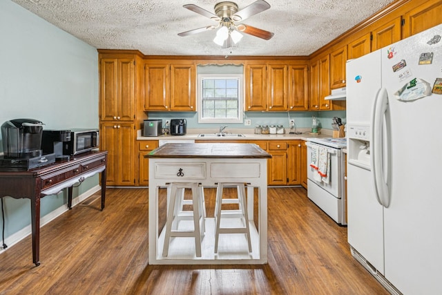 8663 Dog Creek Rd, Primm Springs, TN 38476 - kitchen featuring white appliances, a sink, a textured ceiling, a ceiling fan, and brown cabinetry