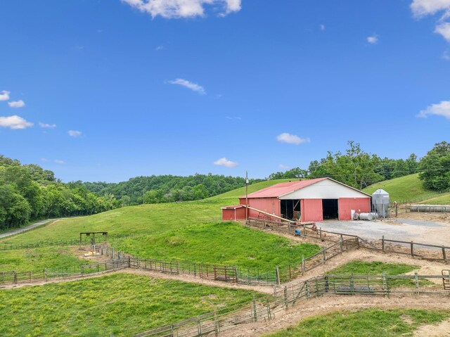 8663 Dog Creek Rd, Primm Springs, TN 38476 - view of yard with a rural view, an exterior structure, an outbuilding, and a garage