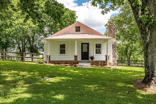 1108 Pruitt Ln, Gallatin, TN 37066 - view of front of house featuring a chimney, a porch, metal roof, and a standing seam roof