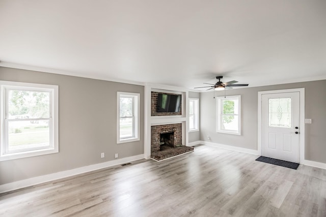 1108 Pruitt Ln, Gallatin, TN 37066 - unfurnished living room featuring a ceiling fan, light wood-style floors, and a brick fireplace