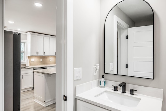 1108 Pruitt Ln, Gallatin, TN 37066 - bathroom featuring vanity, wood finished floors, recessed lighting, and decorative backsplash
