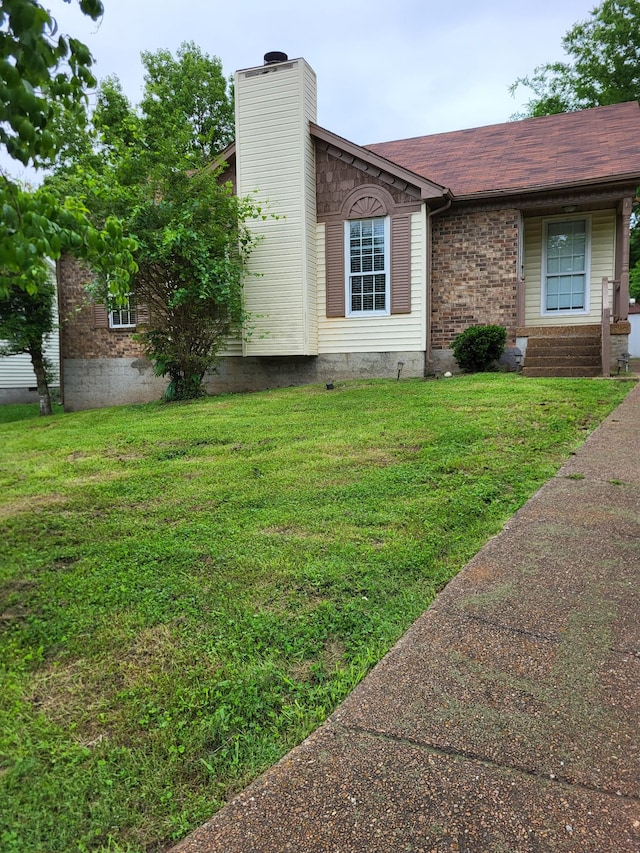 1524 Market Sq, Hermitage, TN 37076 - view of side of home featuring a lawn, a chimney, brick siding, and a shingled roof