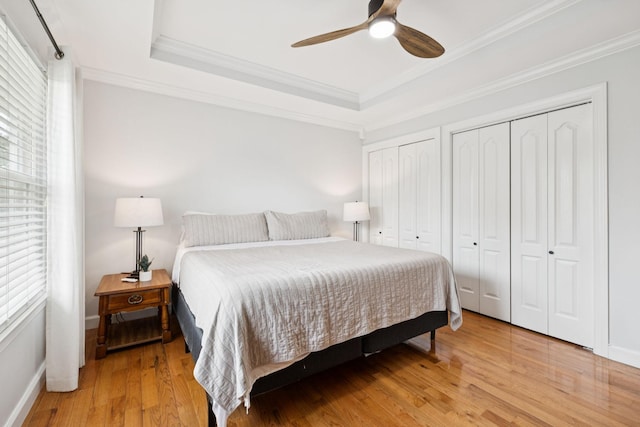 3453 Parkwood Ct, Hermitage, TN 37076 - bedroom featuring a tray ceiling, two closets, wood finished floors, ornamental molding, and baseboards