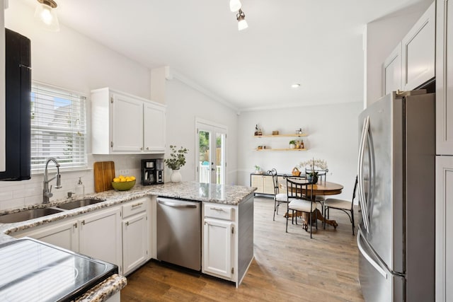 3453 Parkwood Ct, Hermitage, TN 37076 - kitchen featuring appliances with stainless steel finishes, a sink, backsplash, a peninsula, and white cabinetry